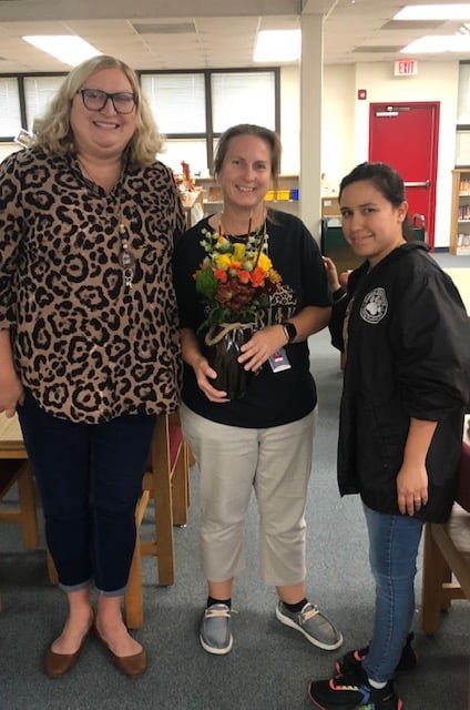 CES principal Cynthia Kubit (left) and assistant principal Christie Suarez (right) congratulate teacher of the year Emma Kinty.